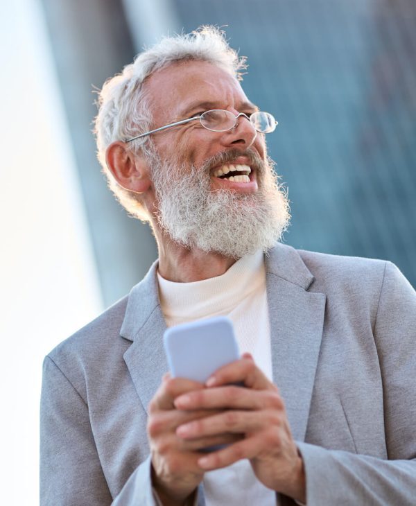 happy-old-professional-business-man-holding-phone-2023-11-27-05-12-40-utc-qxy0d5jmaepd3xidv6vfoaeexwb1xq9wcfd1uilthg